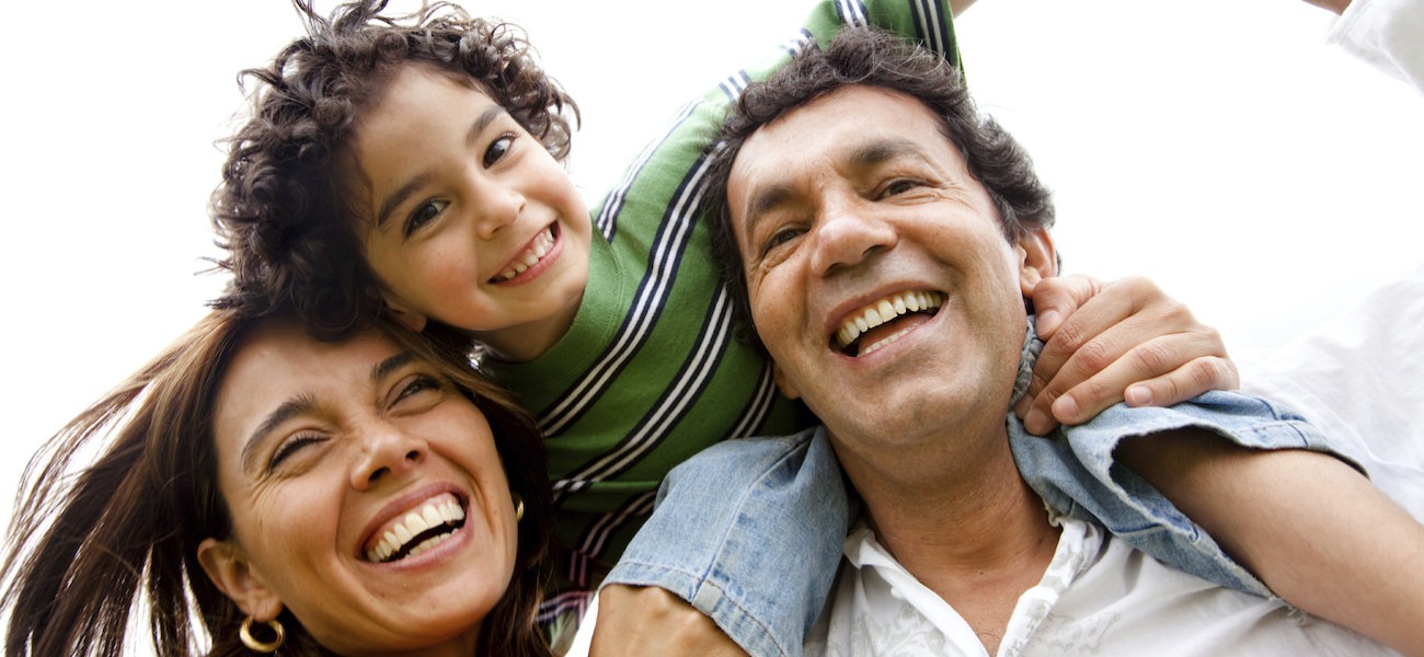 family of 3 smiling and laughing together